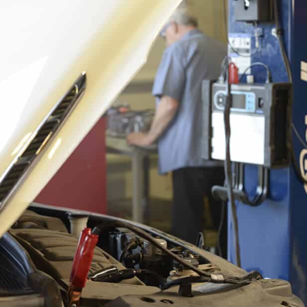 A Midtronics diagnostic system testing a vehicle battery