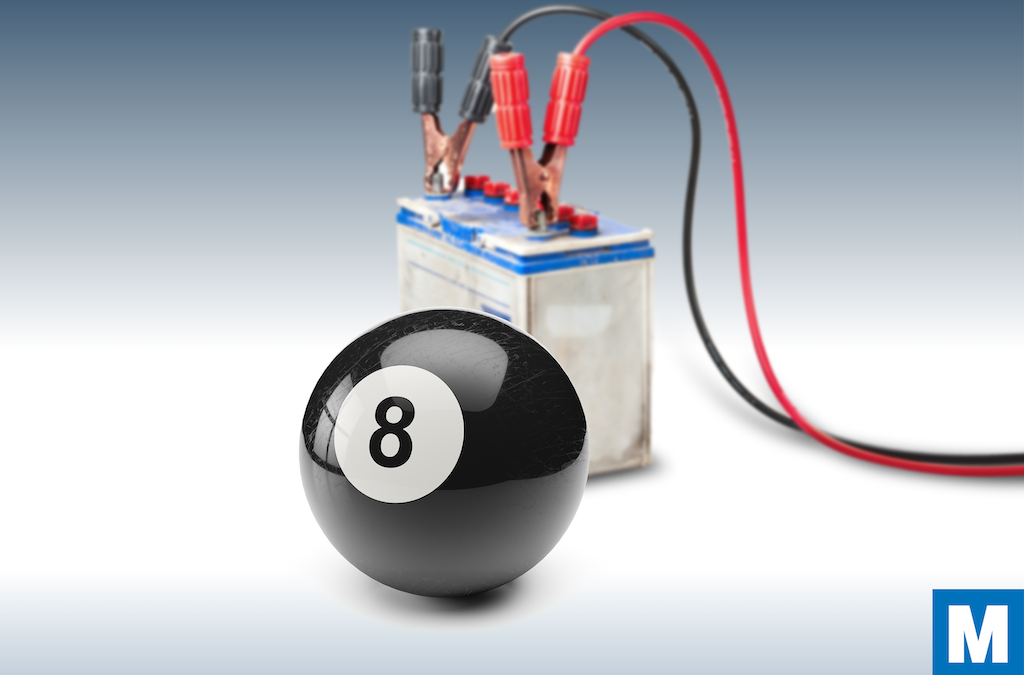 a black 8-ball in front of a car battery